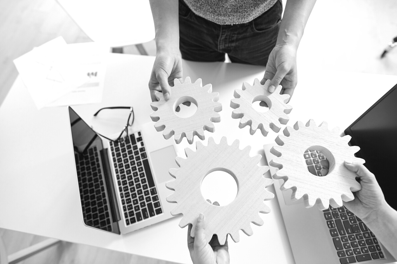 Teamwork, Cooperation and Successful Strategy Concept. Hands of Business People with Gears, Top View